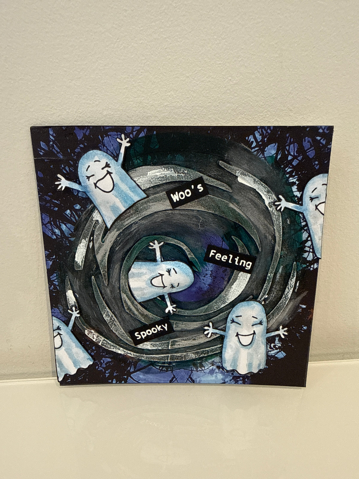card showing cute ghosts and a swirl background