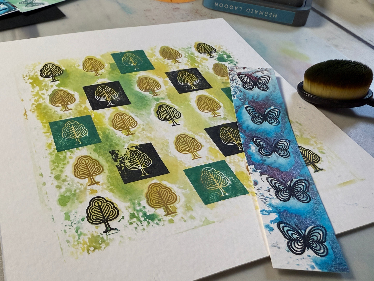 Stamps with tree and butterfly designs on a white surface