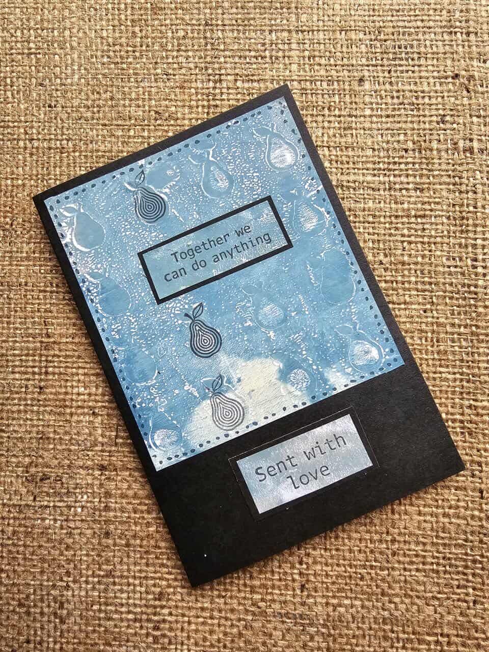 Card with blue design and text on a textured brown background