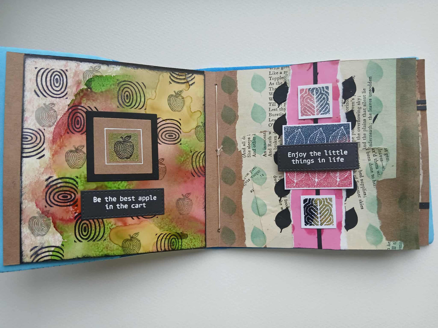 Open book with decorative pages featuring patterns and text on a white background