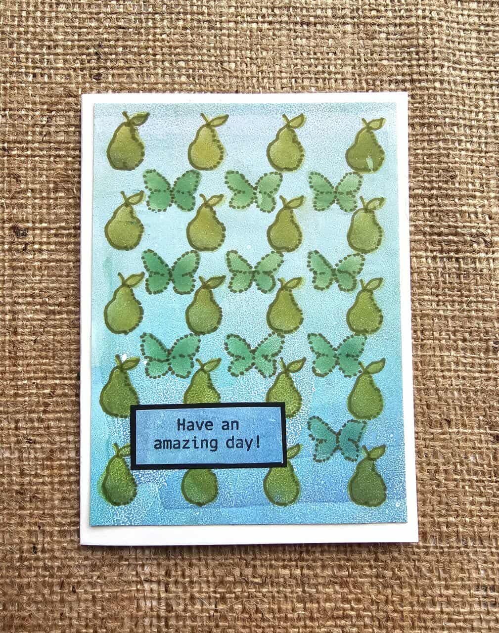 Card with pear and butterfly pattern on a textured brown background