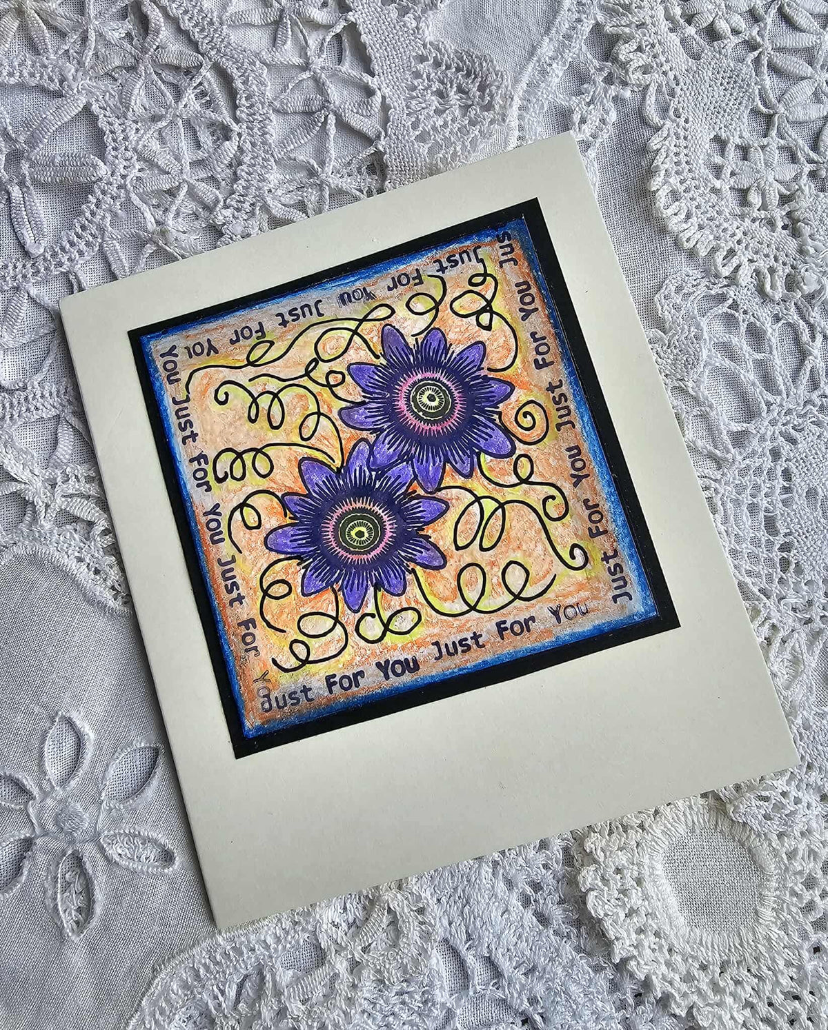 Decorative card with floral design and text on a lace background