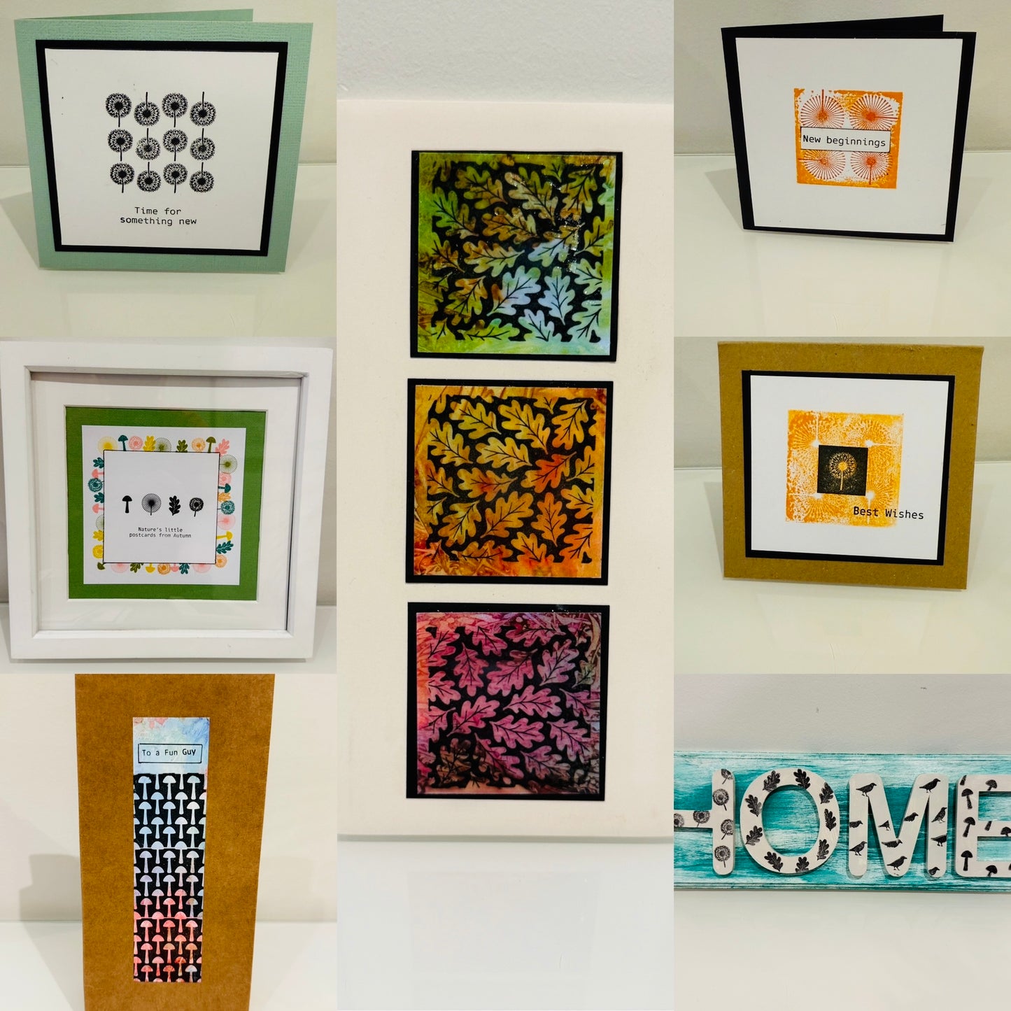 Collection of framed artworks and decorative signs on a white surface