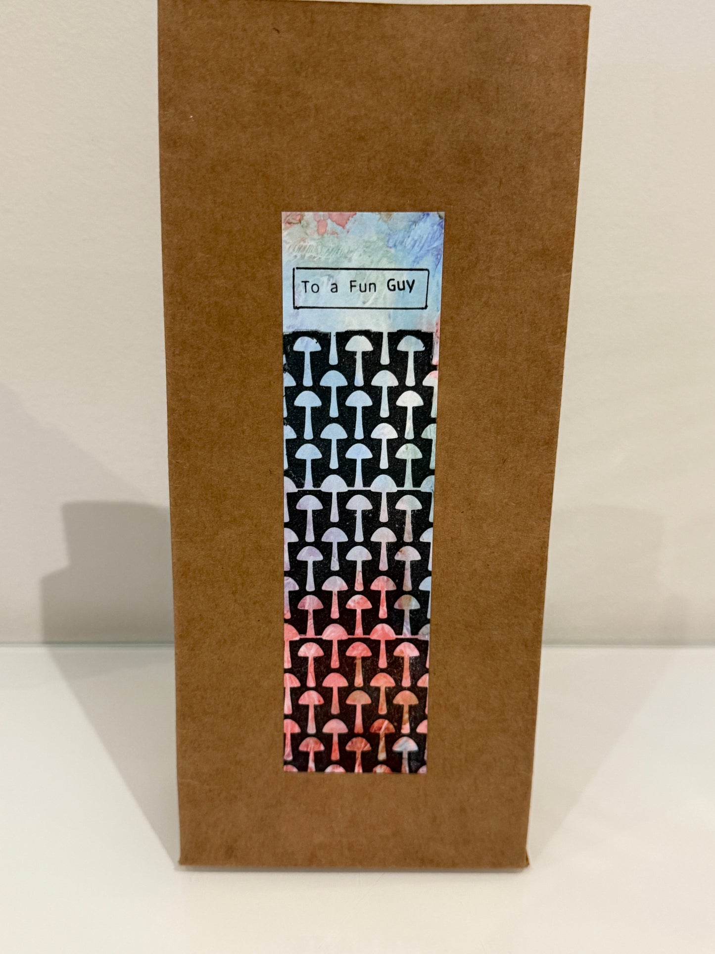 Brown envelope with a mushroom patterned label on a white background
