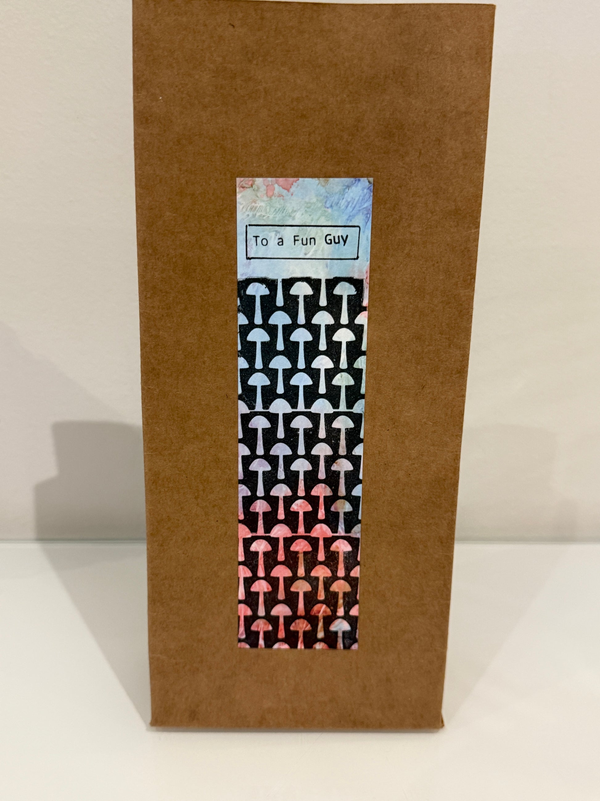 Brown envelope with a mushroom patterned label on a white background
