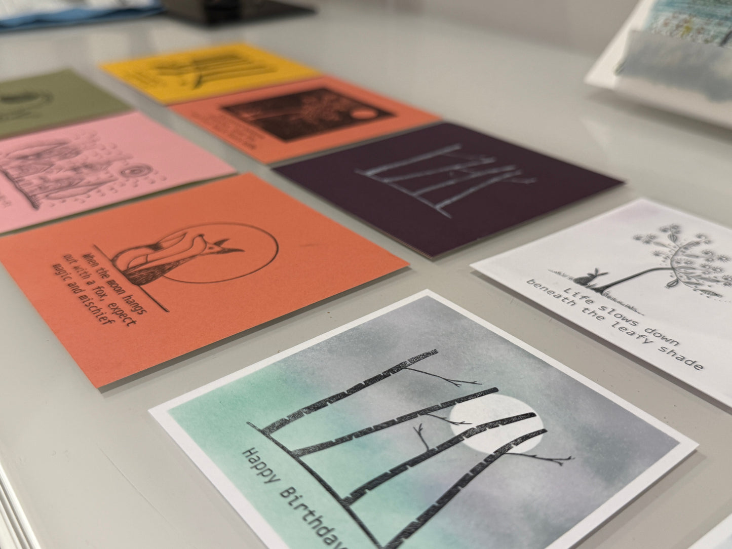 Collection of greeting cards with various designs on a flat surface