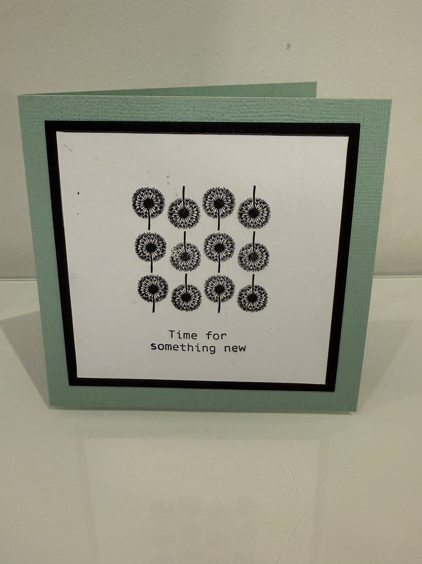 Framed artwork with black and white design on a light gray wall