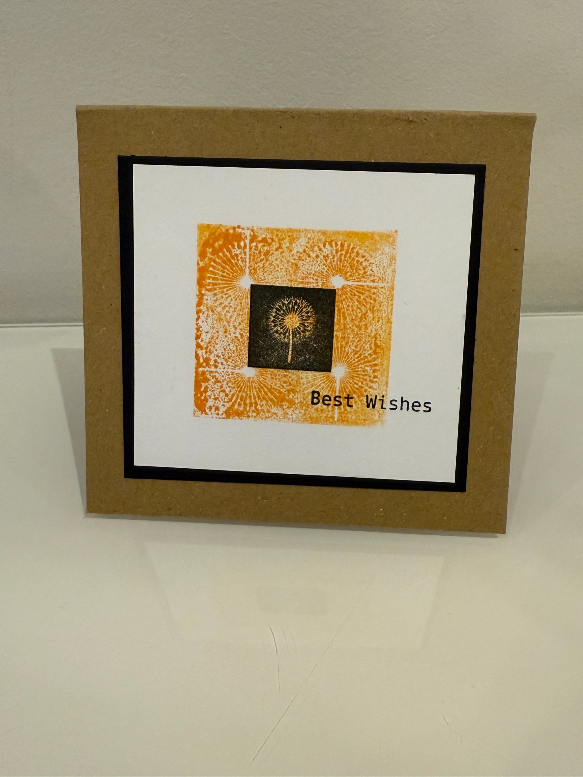 Framed artwork with 'Best Wishes' text on a plain background