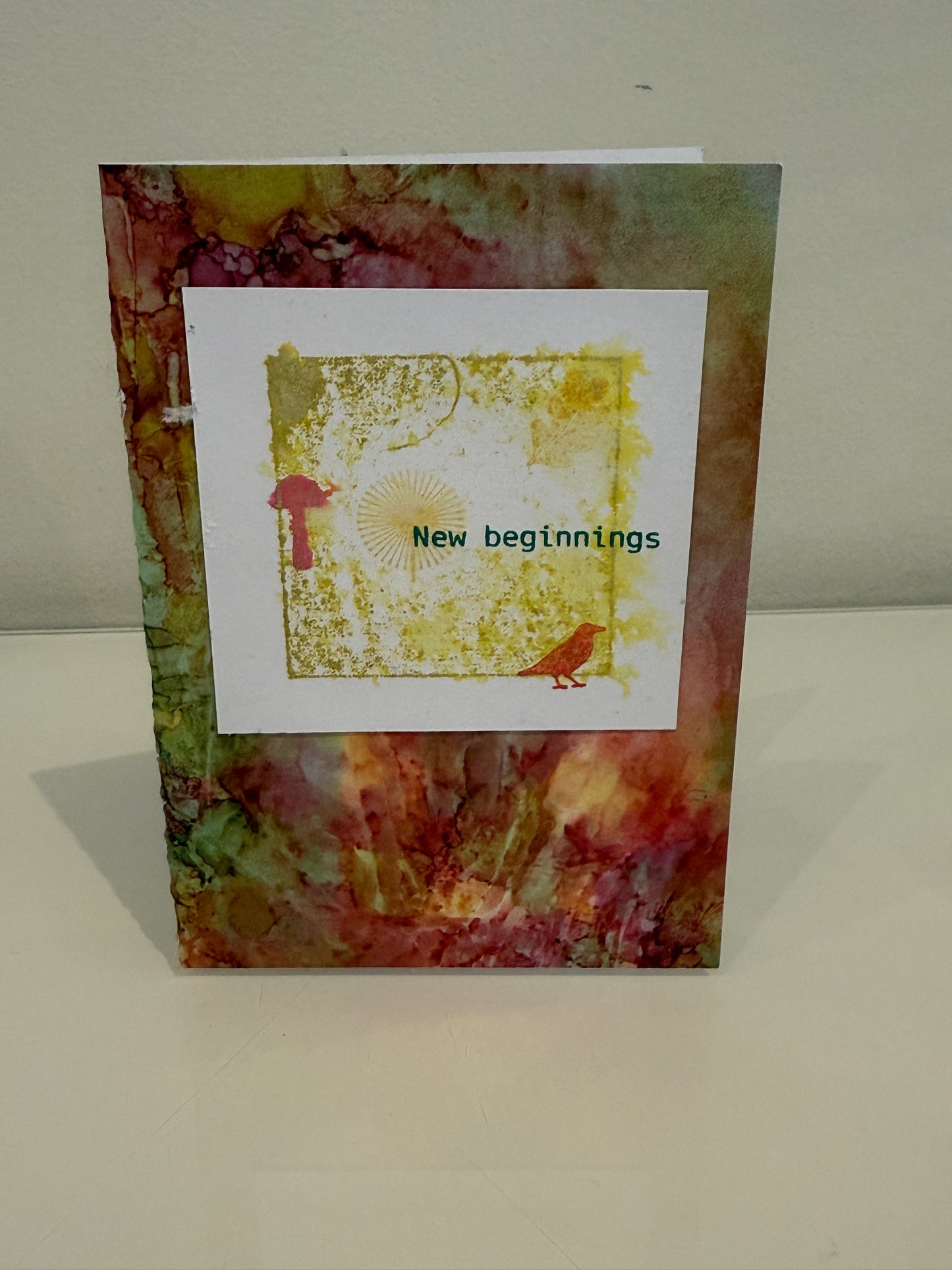 Decorative wall art with abstract design and text on a plain wall.