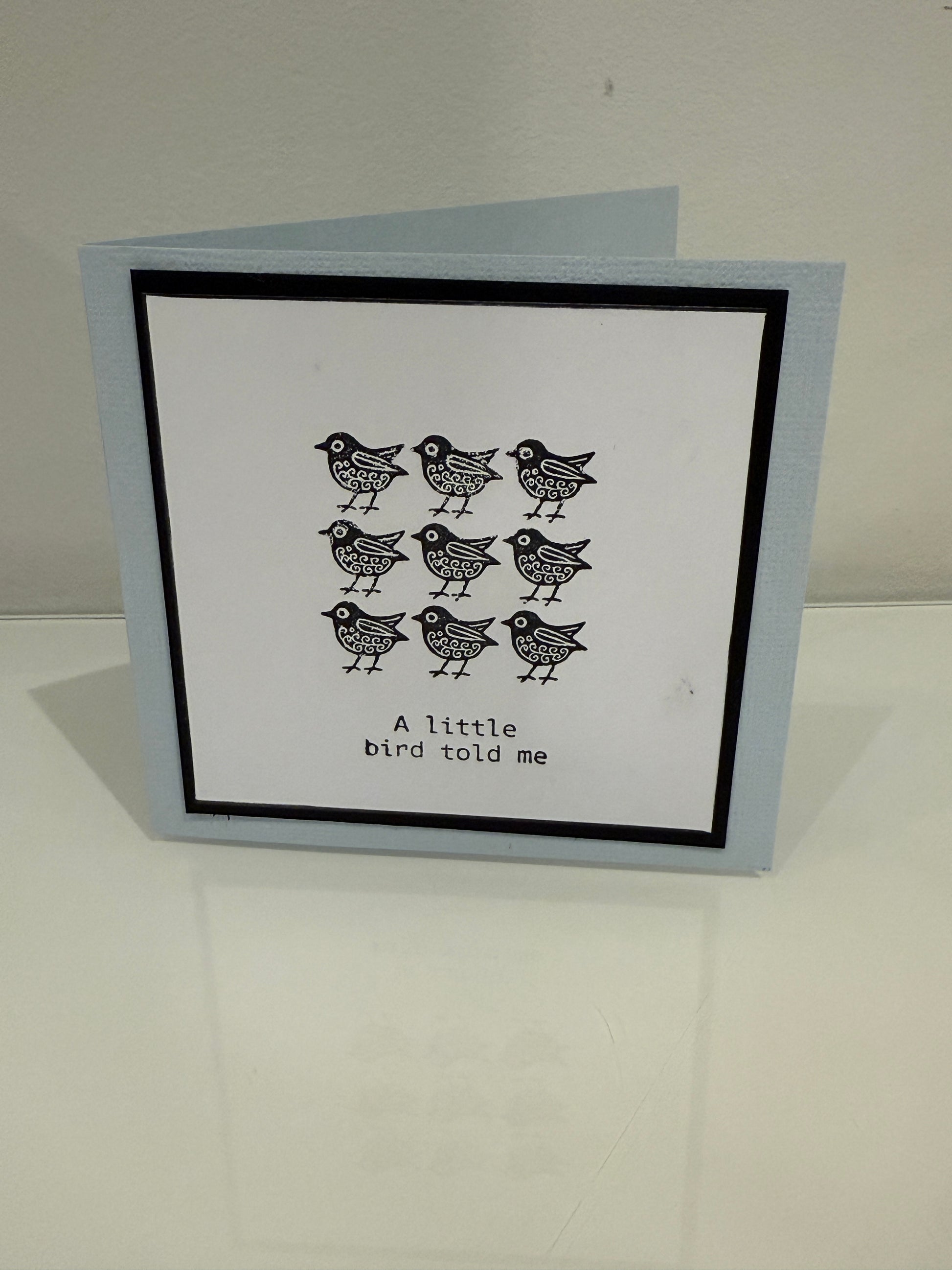 Card with black bird illustrations and text on a white background