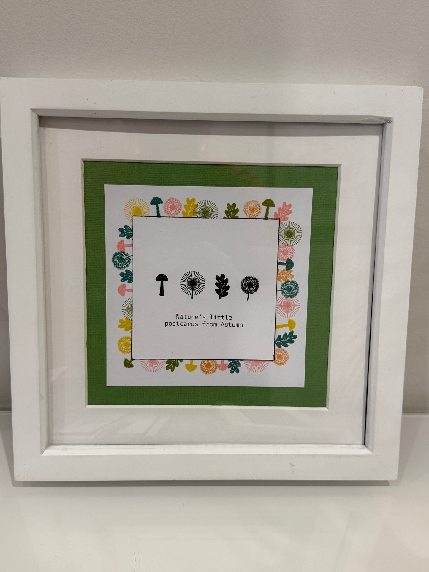 Framed artwork with a white background and decorative elements