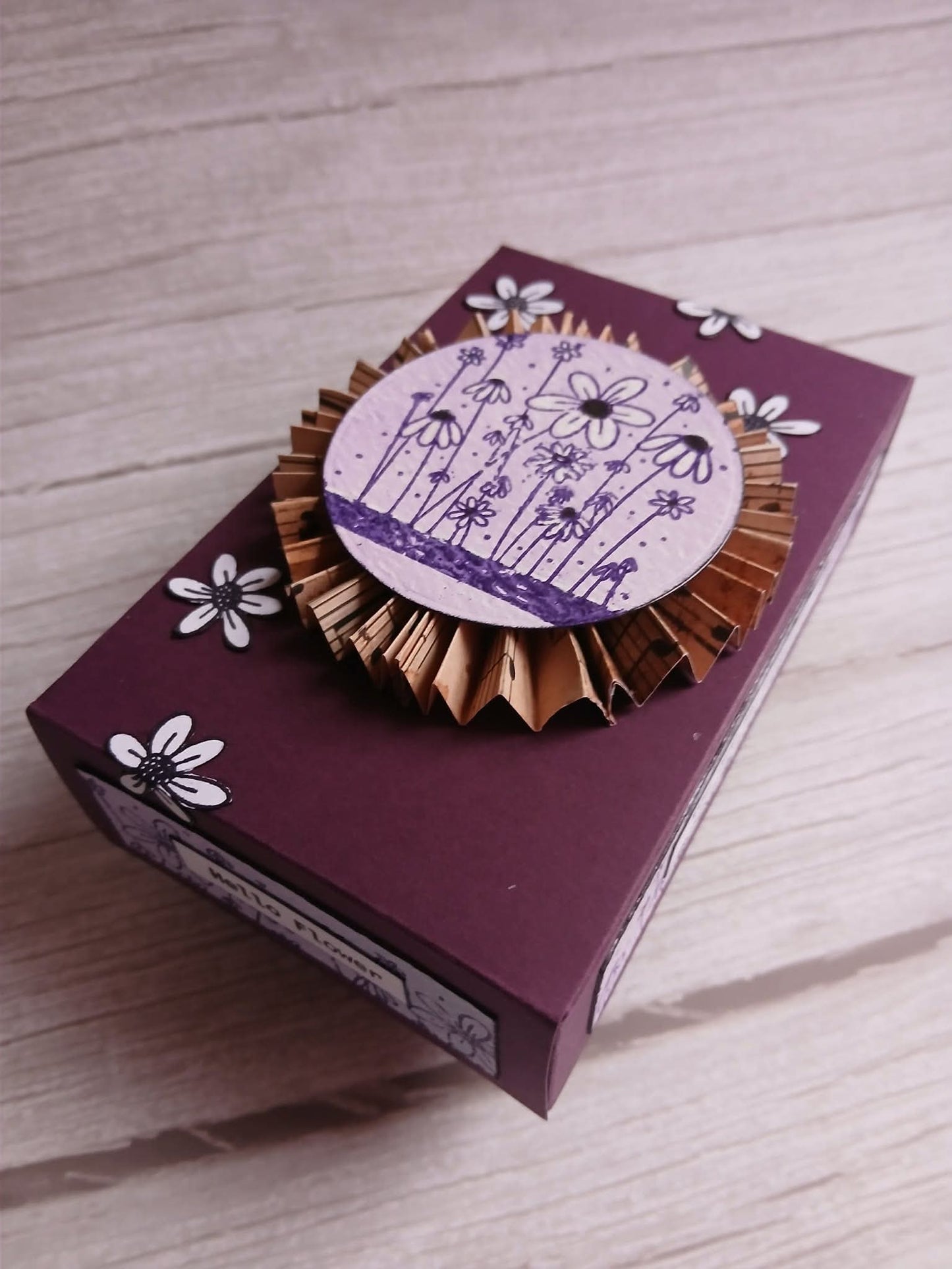 Decorative box with floral design on a wooden surface
