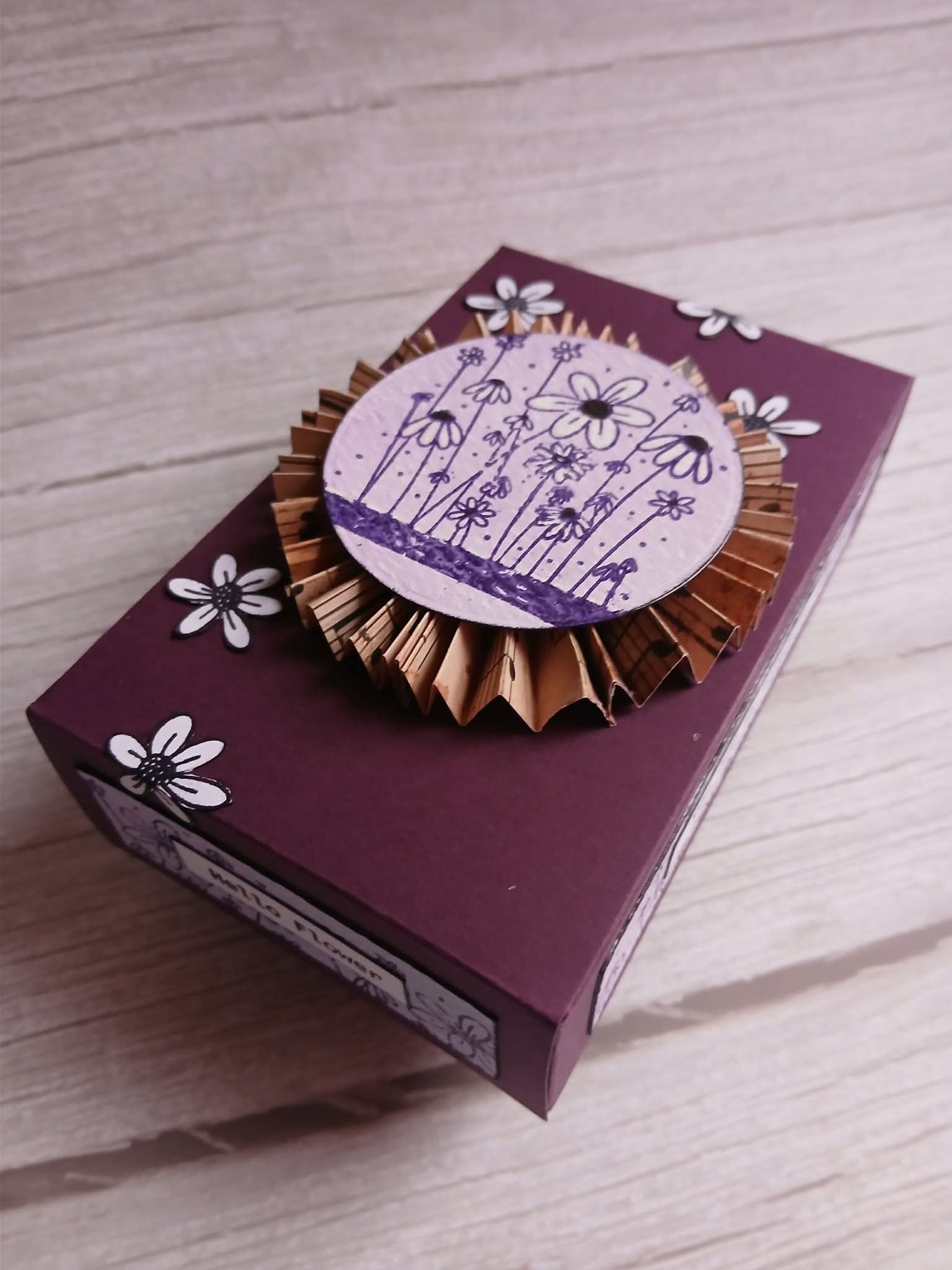 Decorative box with floral design on a wooden surface