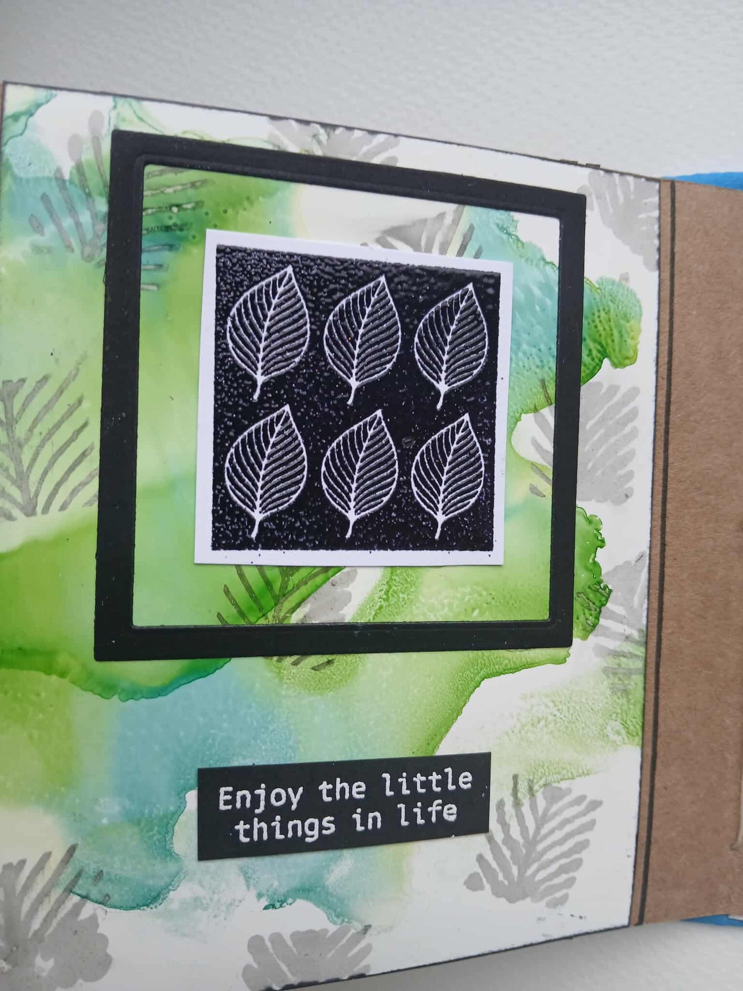 Card with leaf design and text 'Enjoy the little things in life' on a watercolor background
