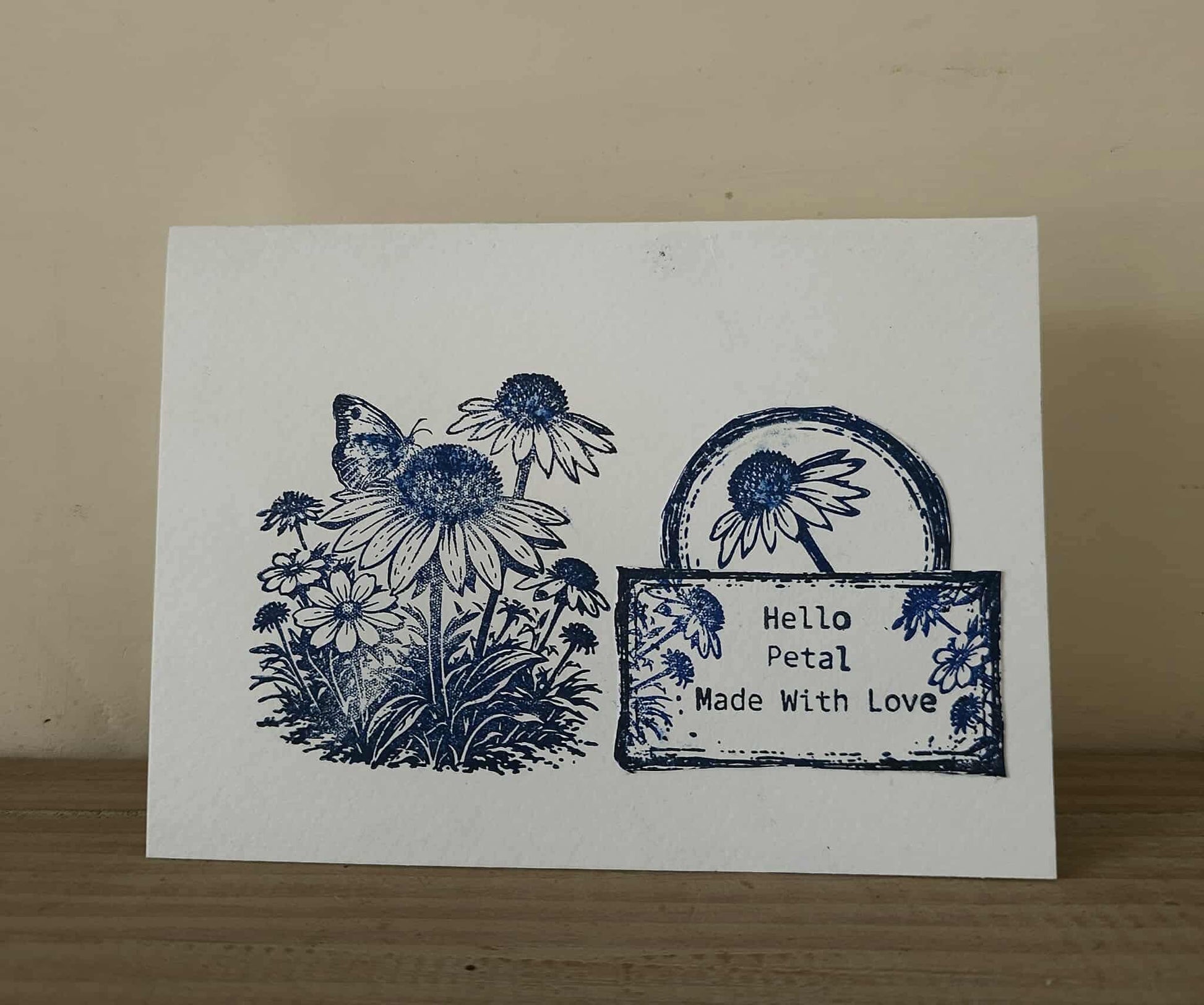Card with blue floral design and 'Hello Petal Made With Love' text on a beige background