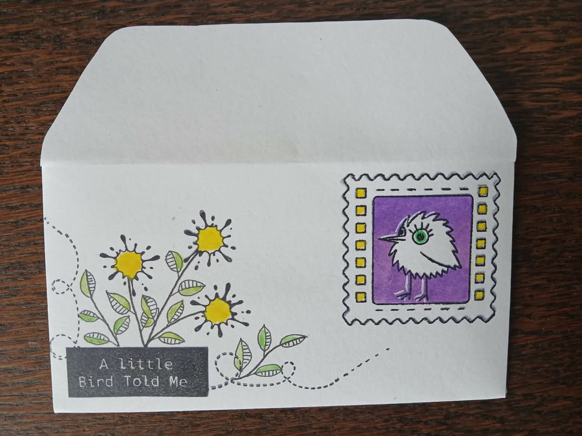 envolope with artwork of a bird and flowers made from paint splats