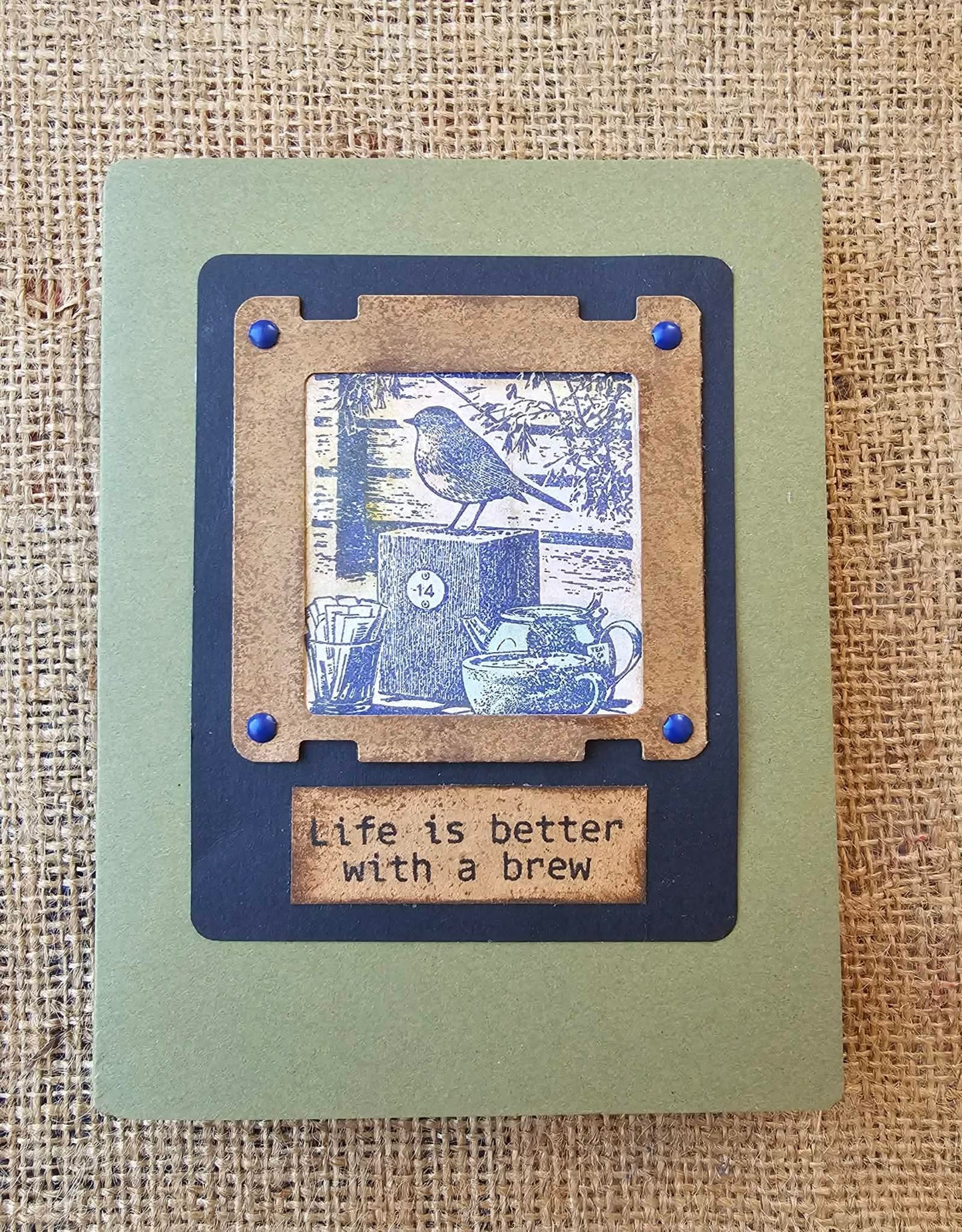 Card with a blue and brown design featuring a bird and text on a textured background