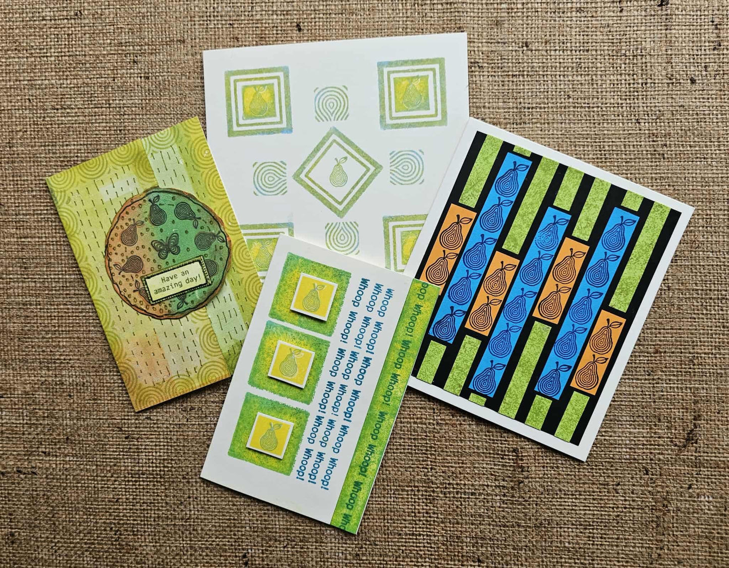 Set of greeting cards with geometric patterns on a textured fabric background