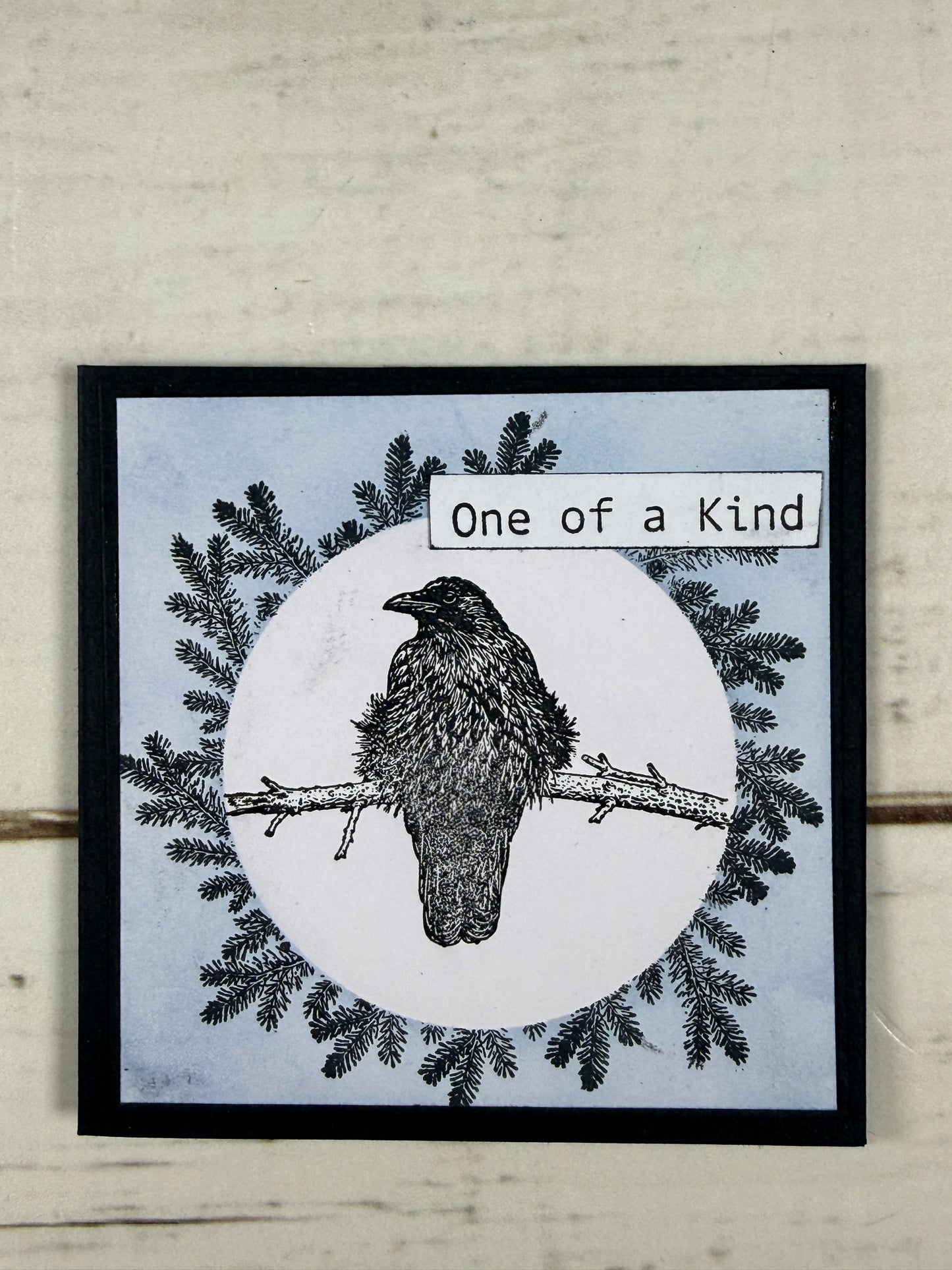Framed artwork with a bird illustration and text on a textured wall.