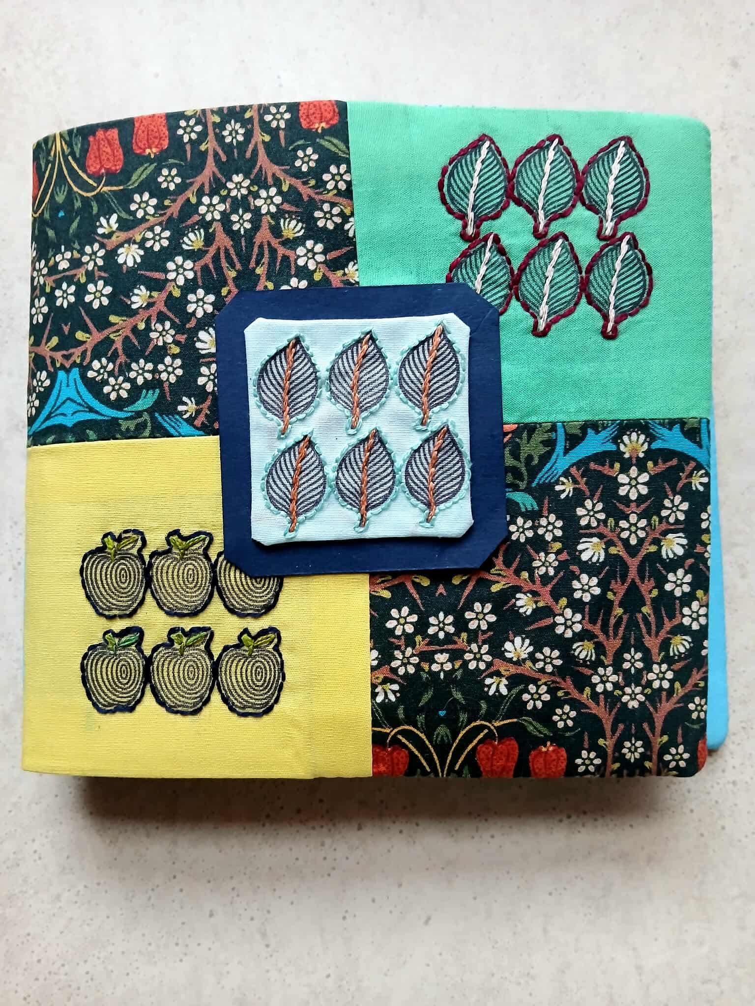 Stack of fabric with various patterns on a light gray background
