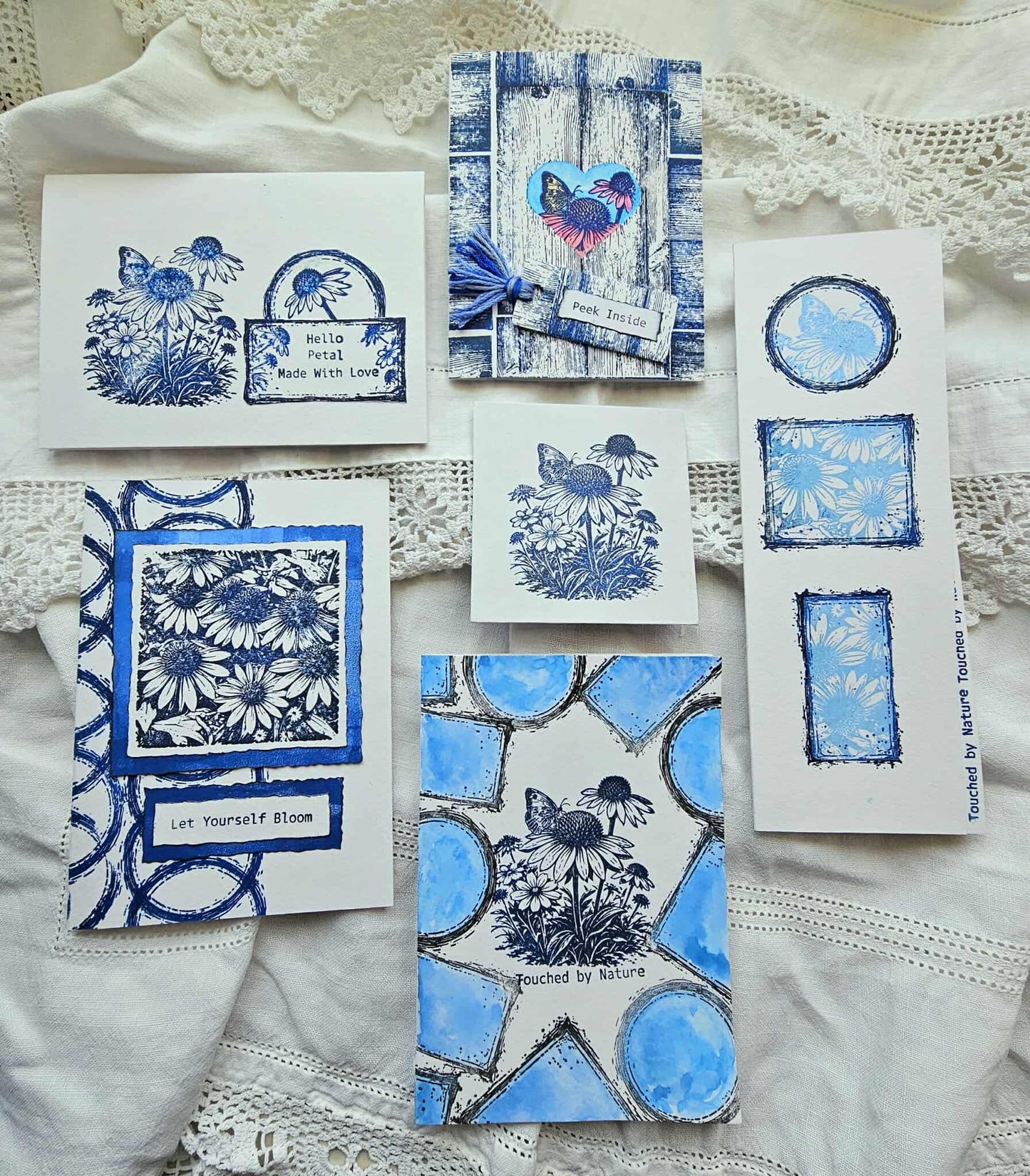 Collection of blue and white greeting cards on a textured surface