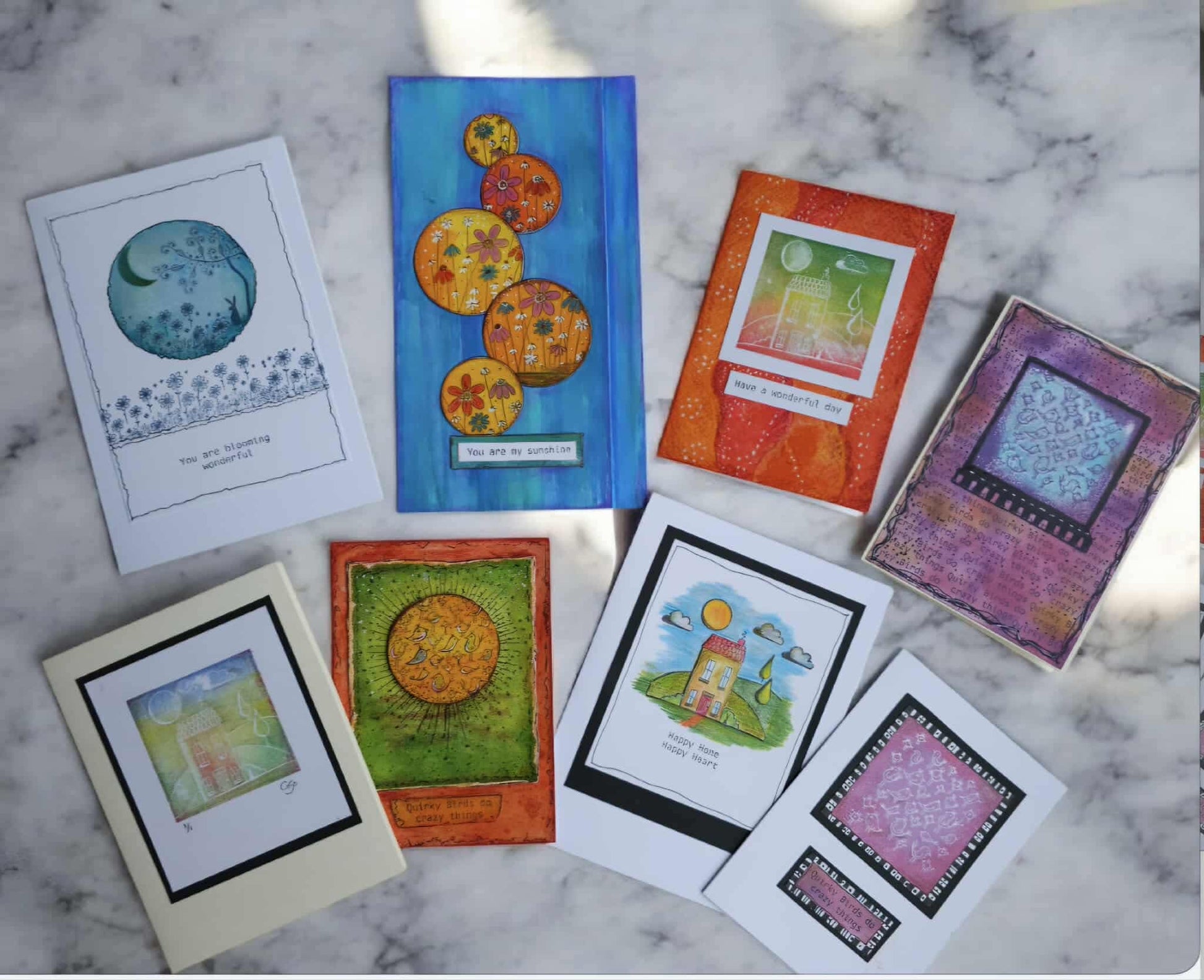 Collection of colorful greeting cards on a marble surface