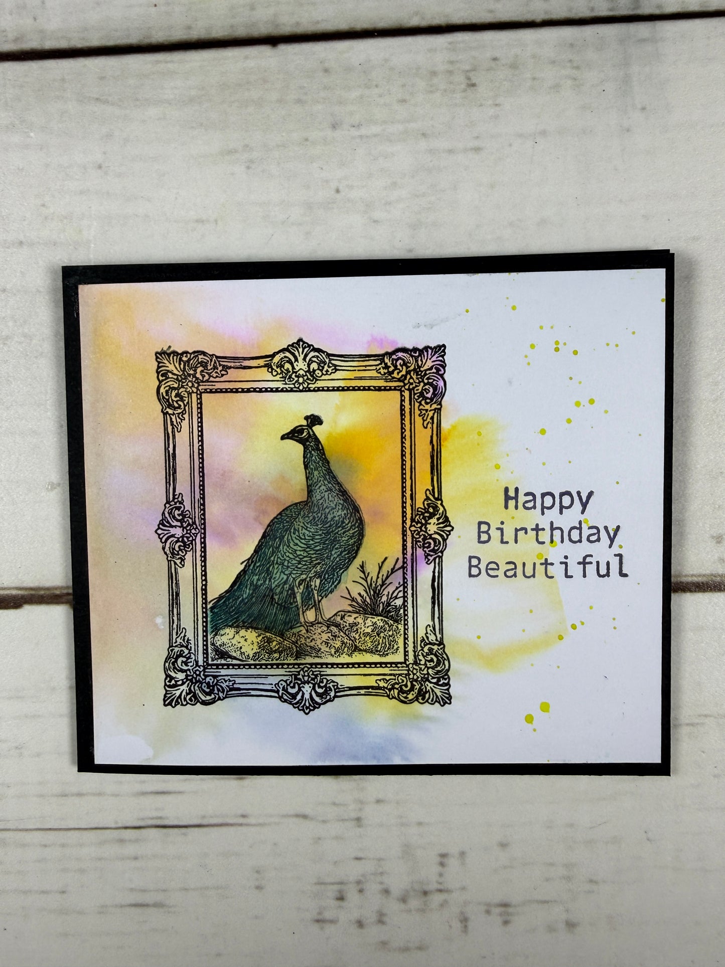 Greeting card with ornate frame and 'Happy Birthday Beautiful' text on a watercolor background.