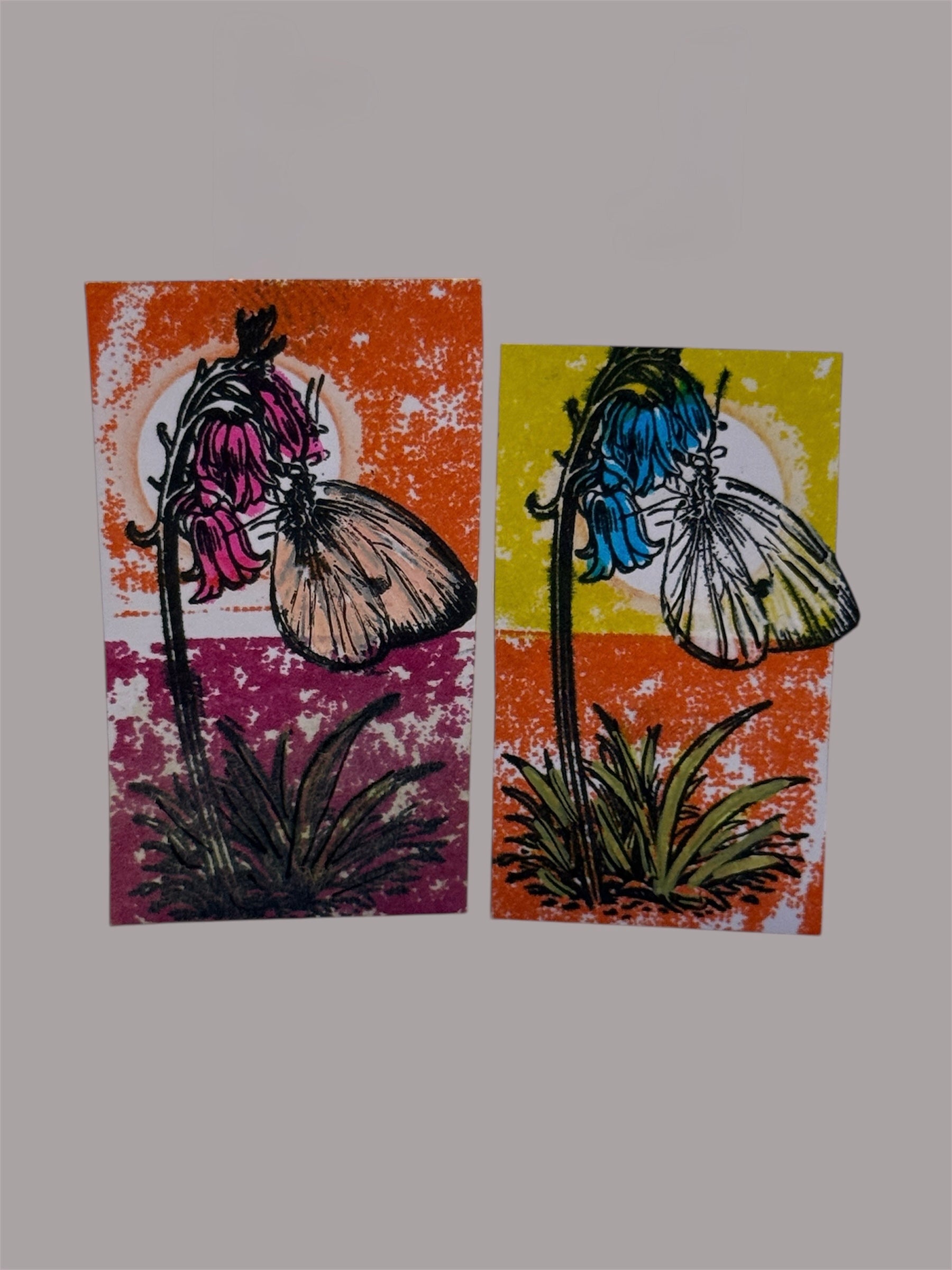Two floral stamps with butterflies on textured backgrounds