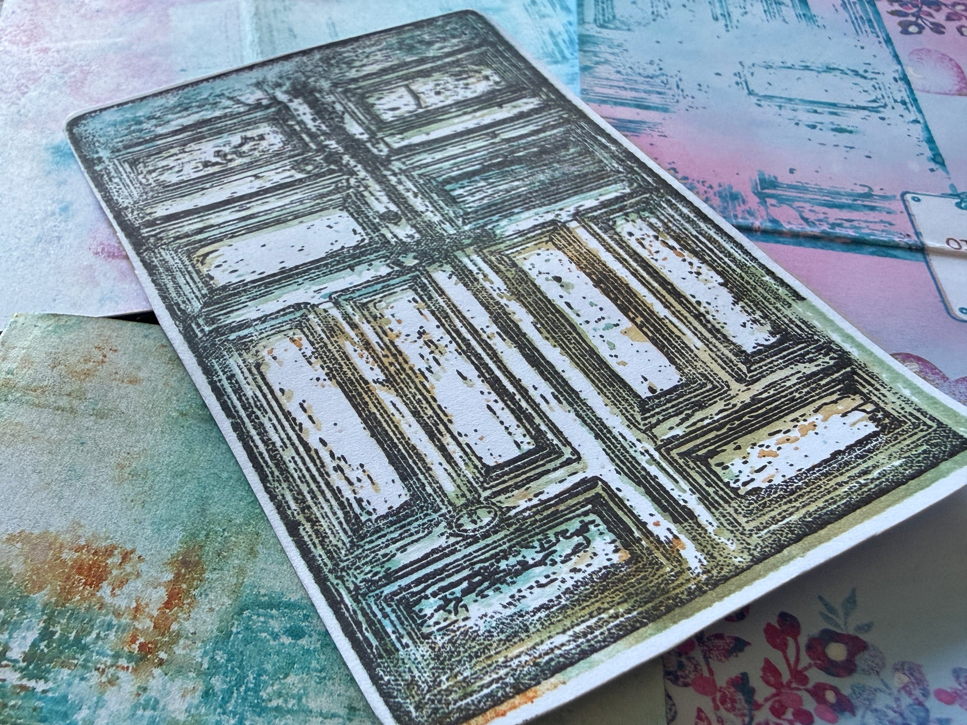 Decorative metal embossing folder with textured design on a colorful background