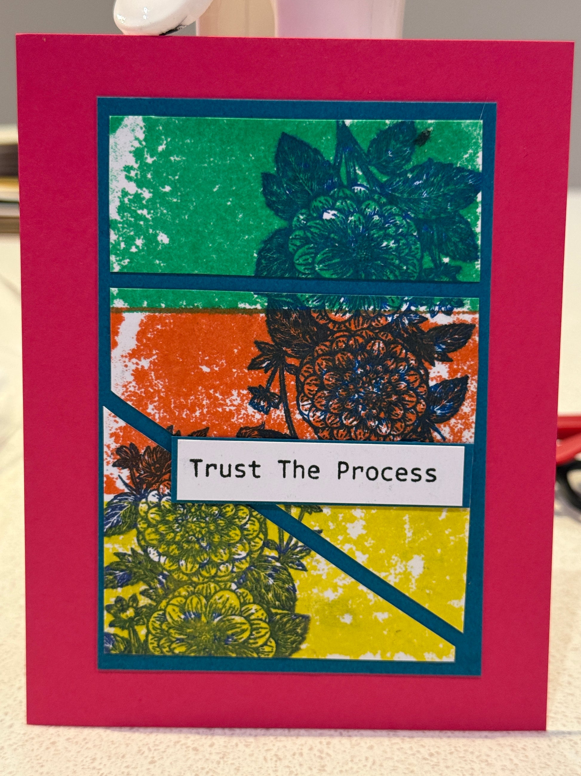 Card with floral design and motivational text on a pink background