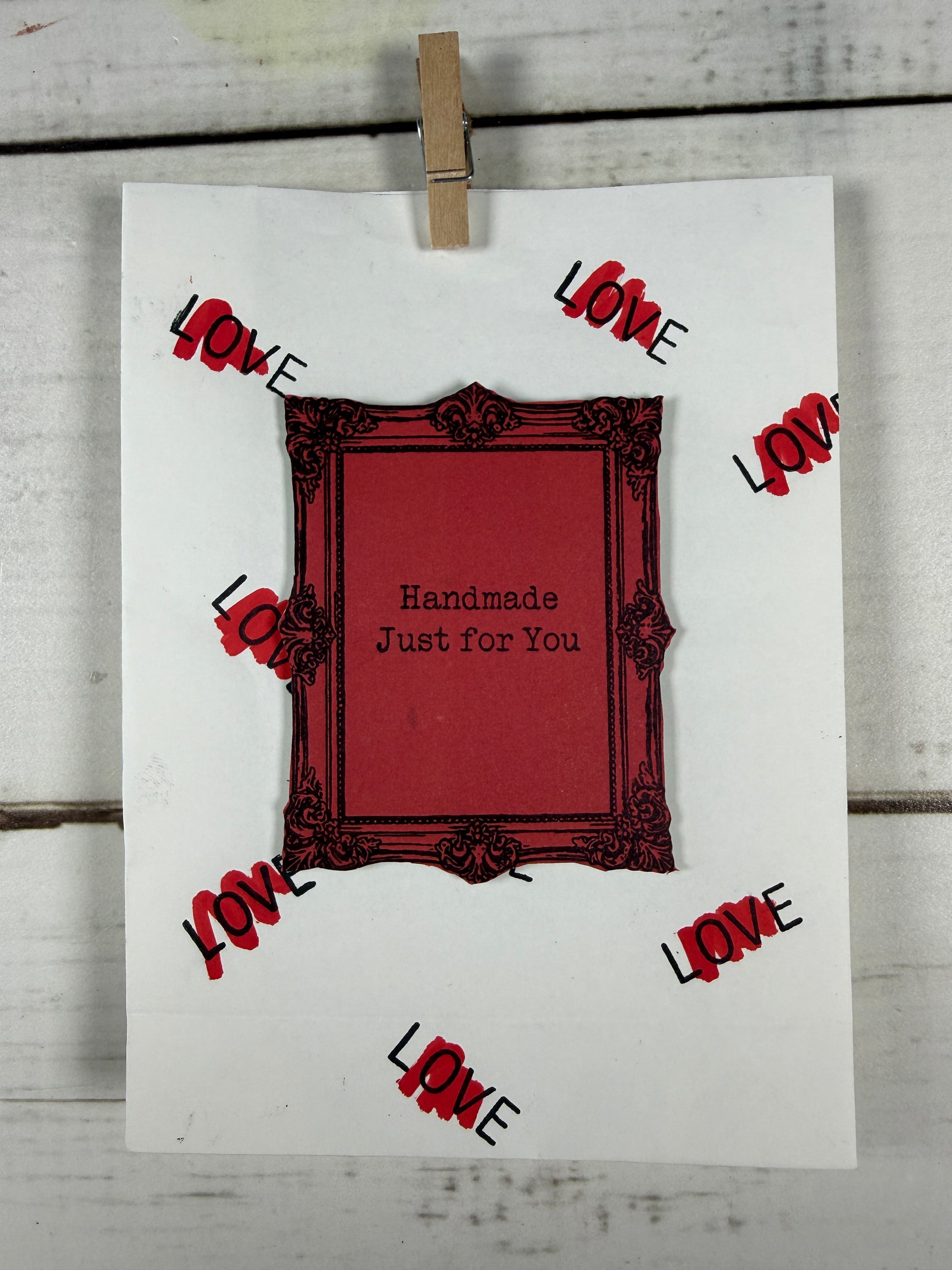 Card with a red frame and 'Handmade Just for You' text, surrounded by decorative 'LOVE' elements on a white background.