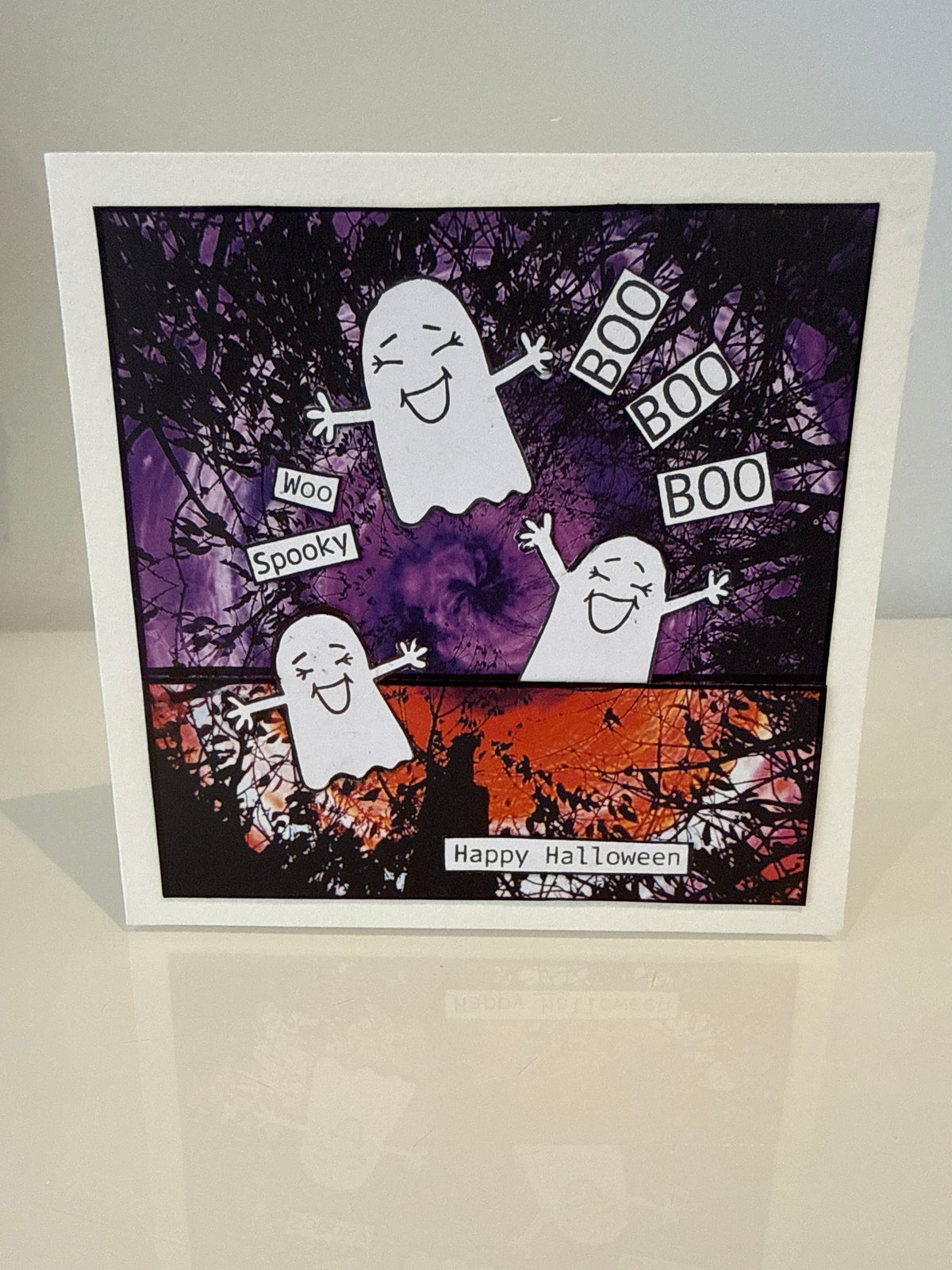 Laughing cute ghosts on a colourful paper background