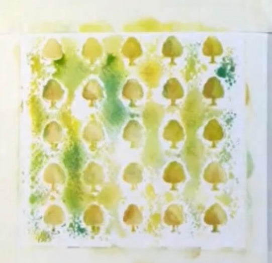 Stamped paper with green and yellow pattern on a white surface