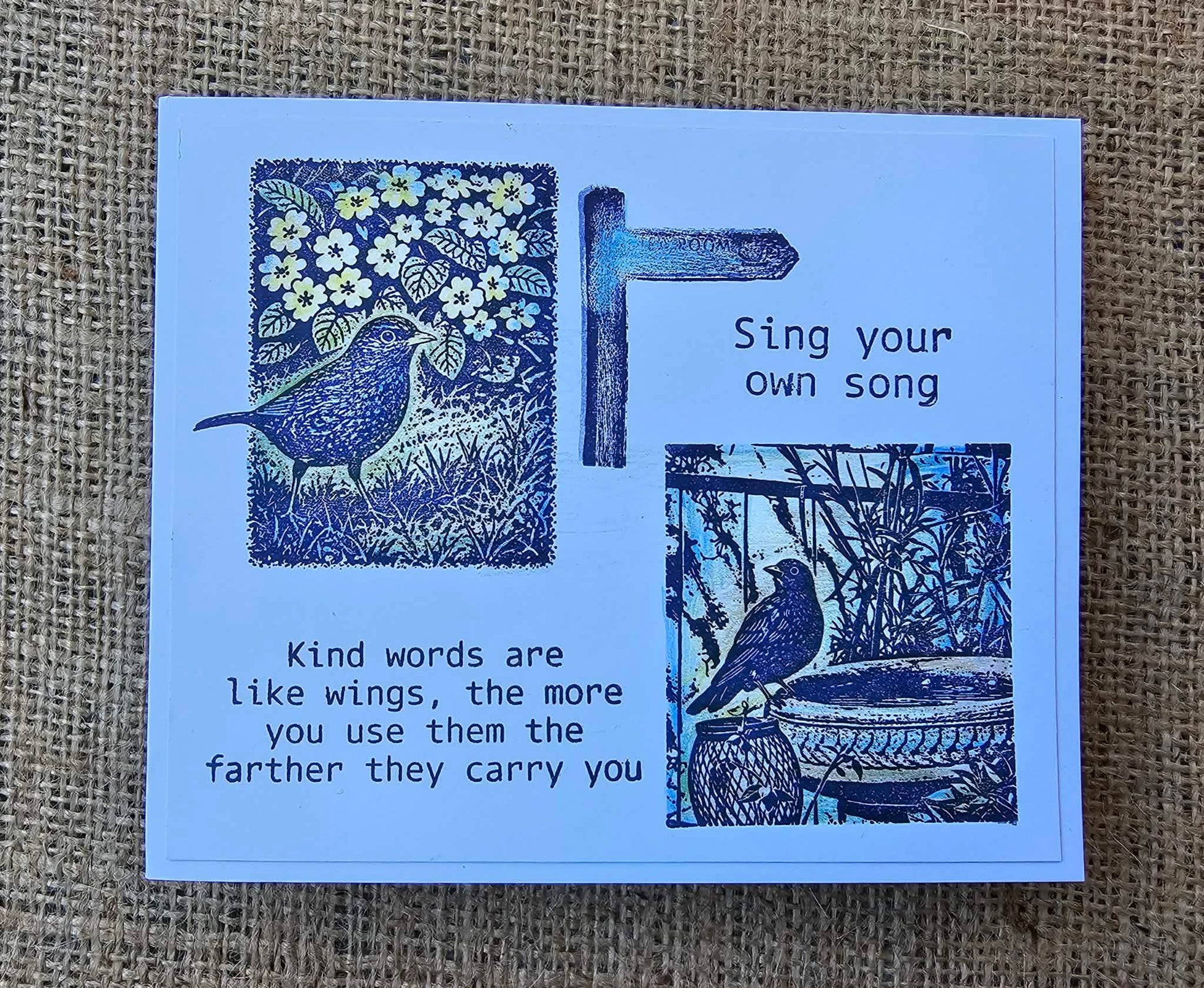 Blue card with bird illustrations and text on a textured brown background