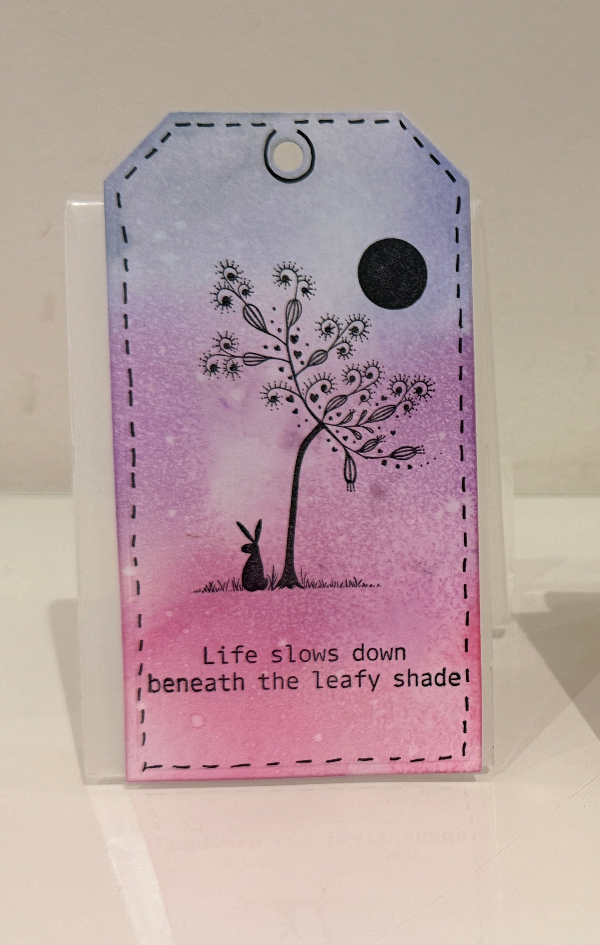 illustration of hare sitting under a tree with text