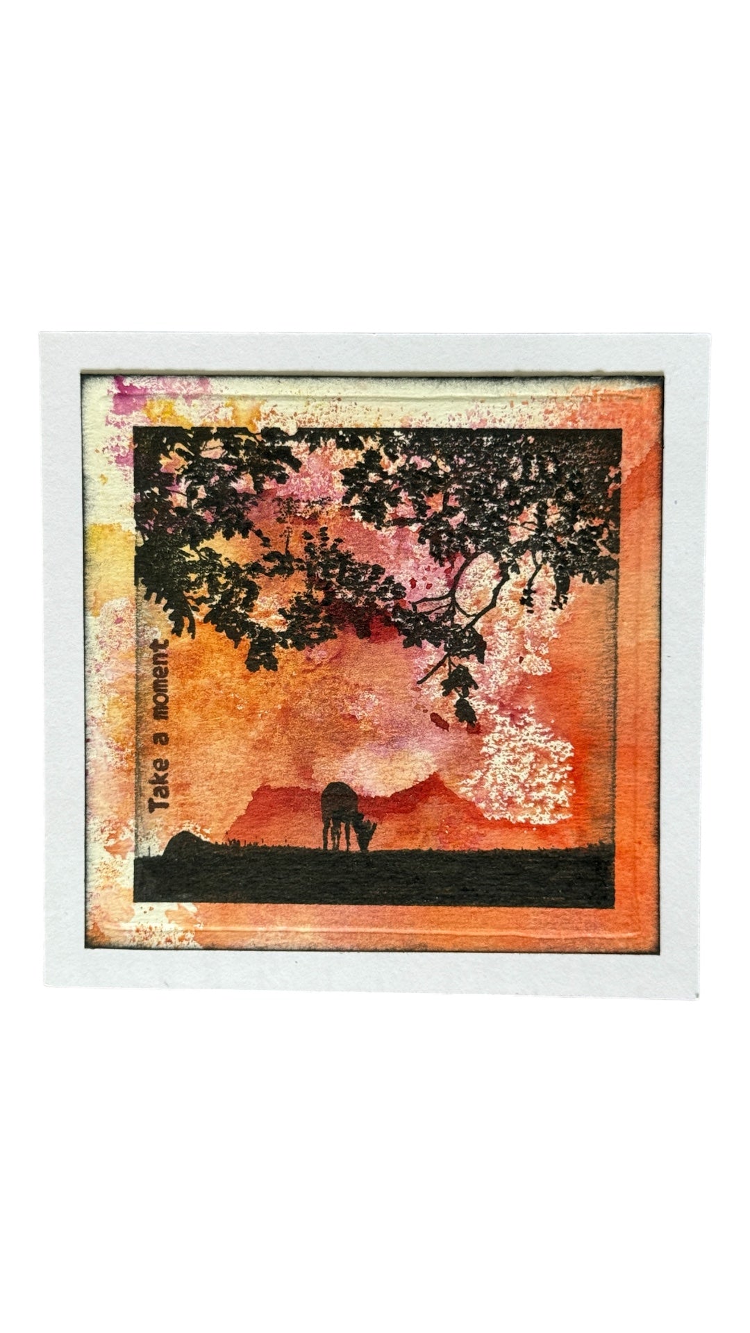 deer on a hill under a tree