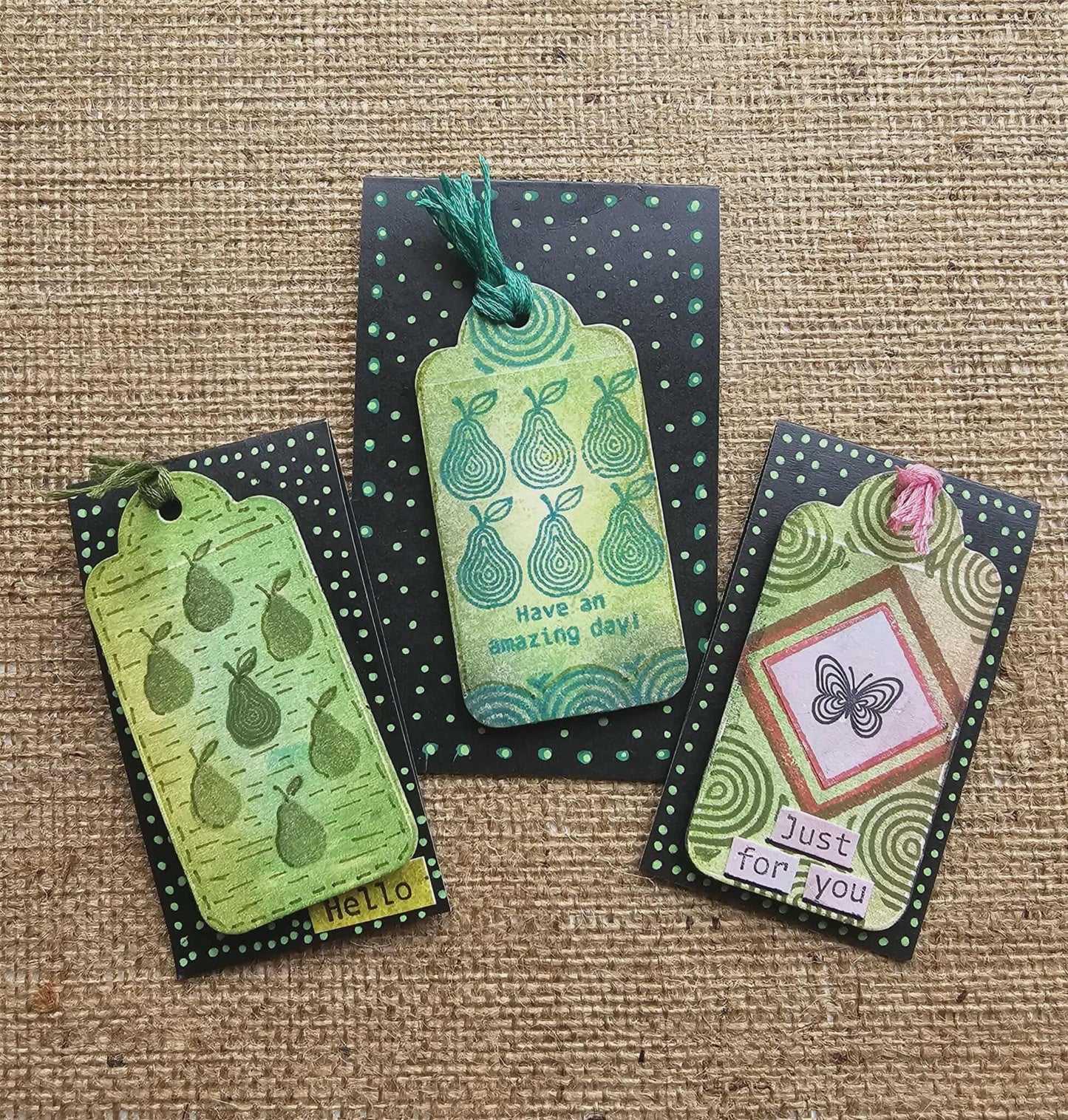 Set of decorative gift tags with various designs on a textured surface