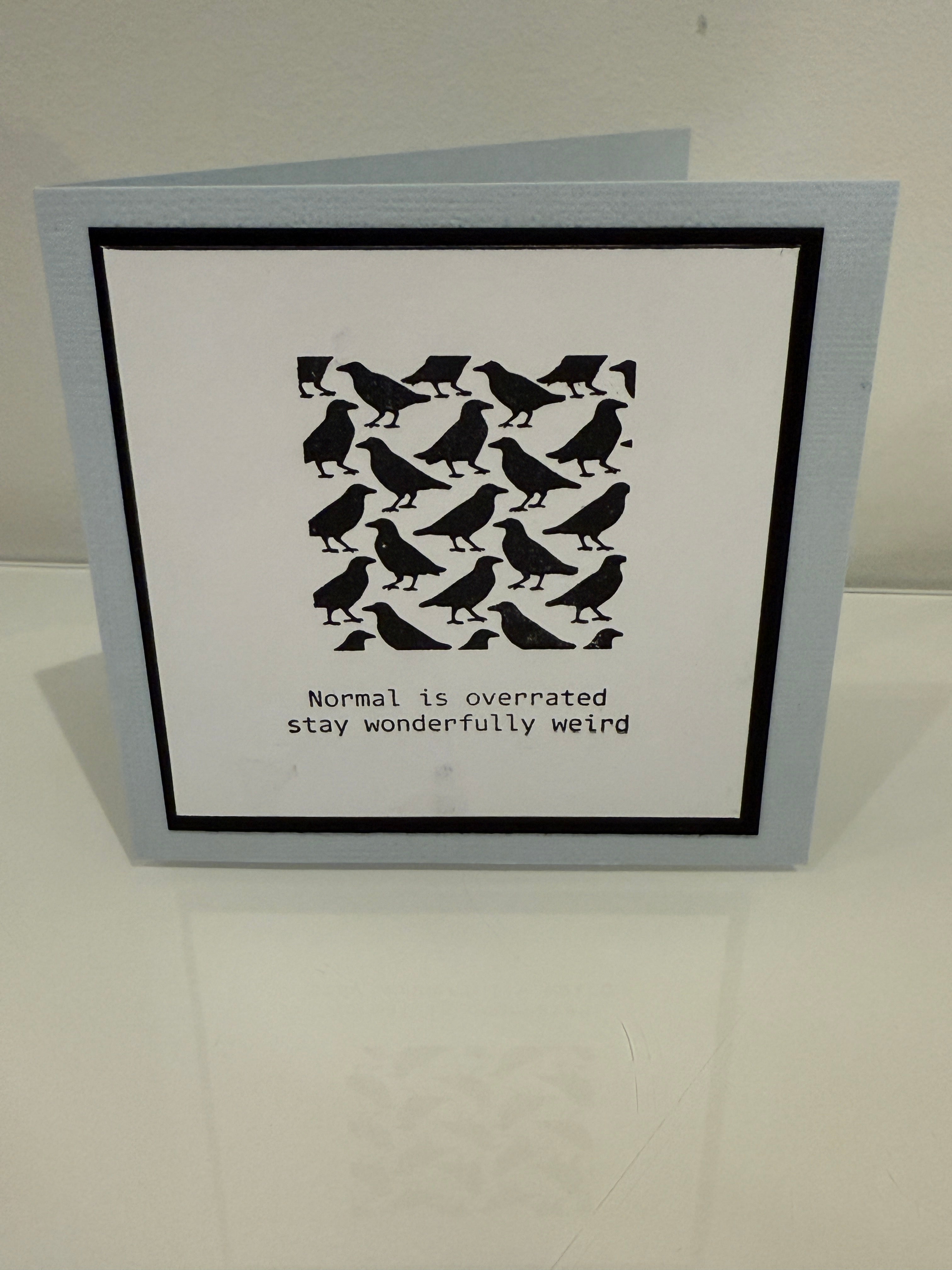 Card with black and white pattern and text on a light gray background