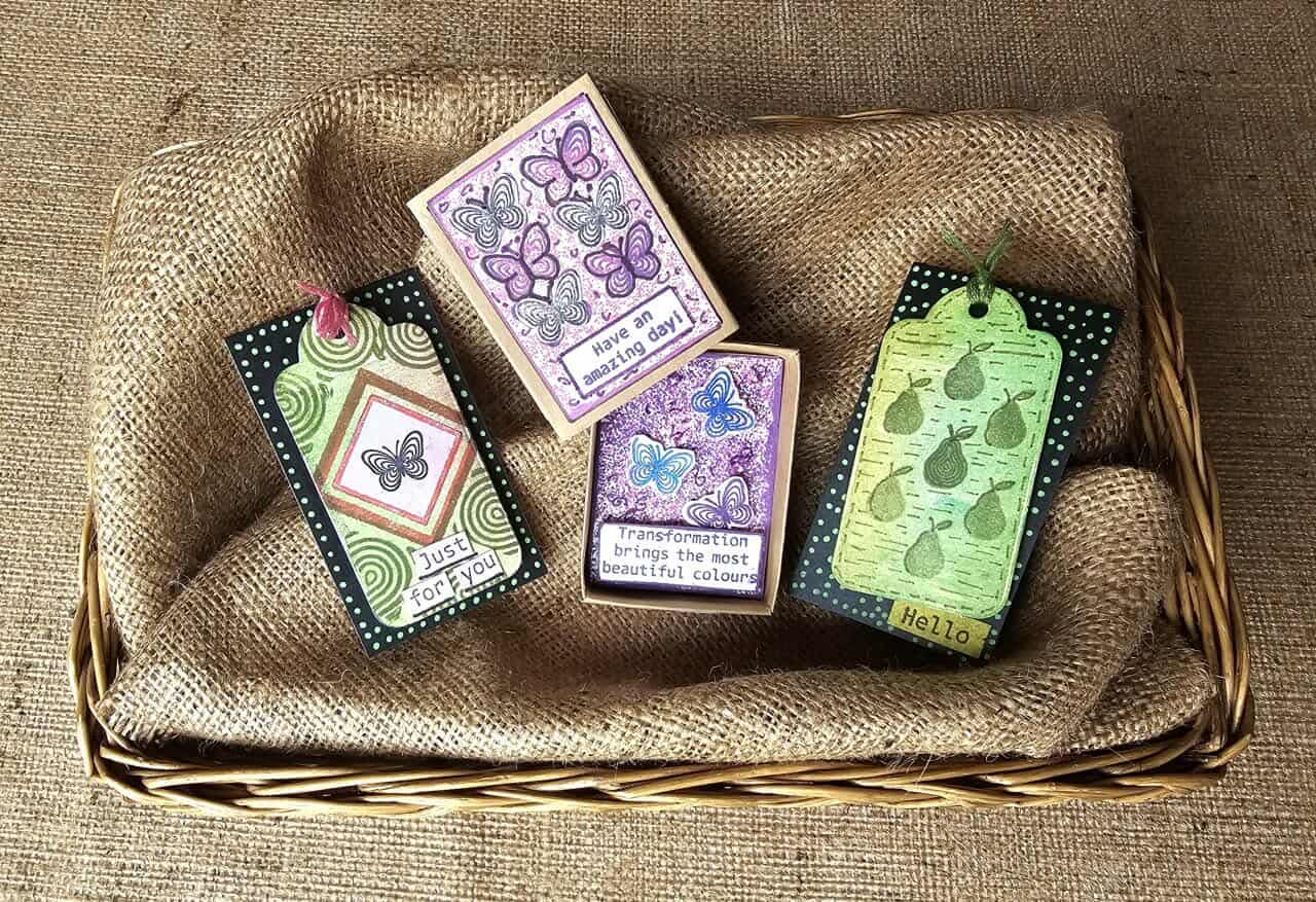 Set of decorative tags with butterfly designs on a woven basket and burlap fabric background