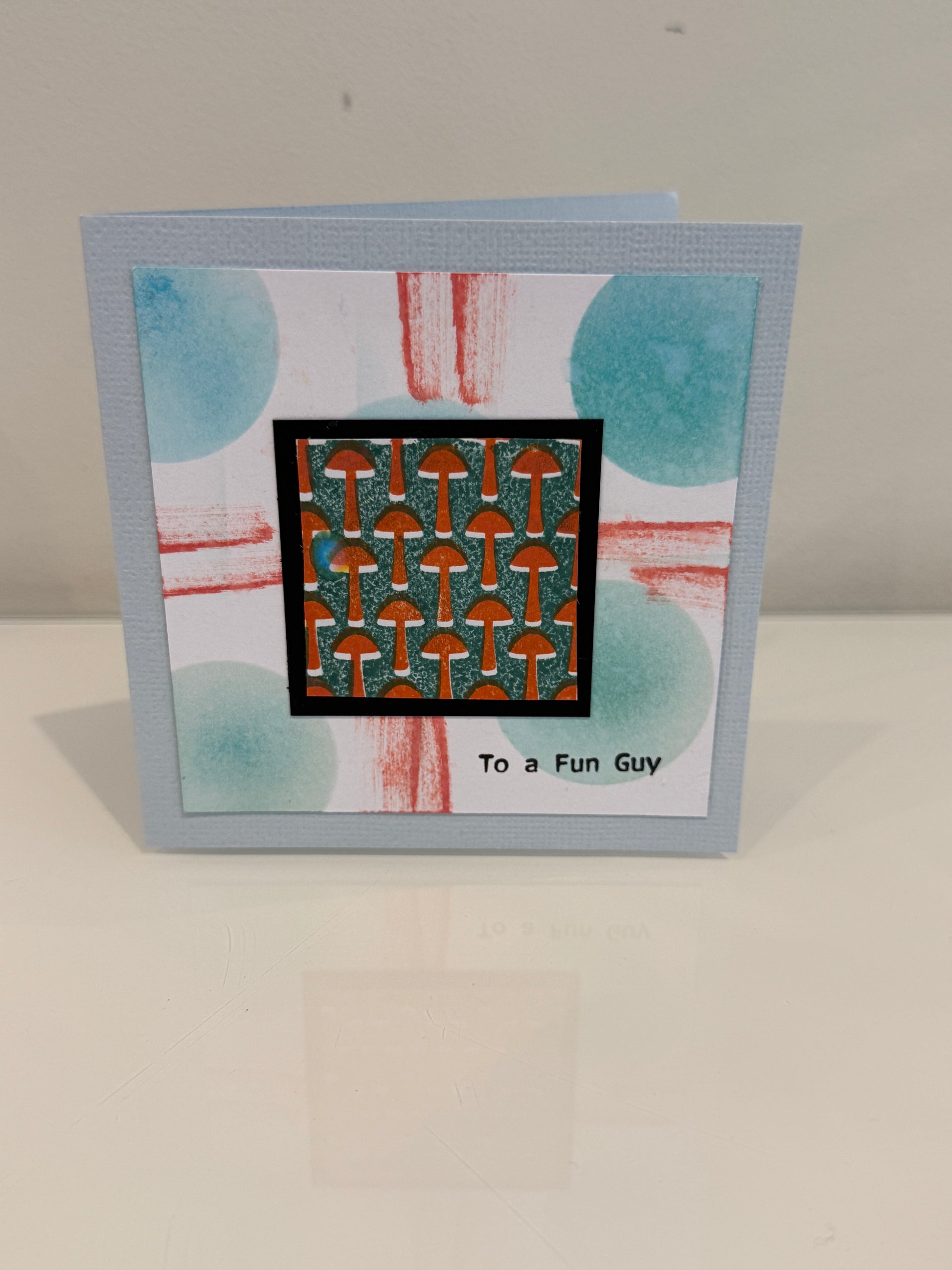 Greeting card with geometric design and text on a plain background